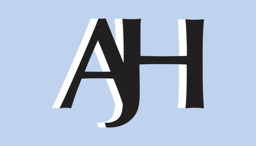 The Front of Annie's Business Card with her AJH brand logo with a light blue background